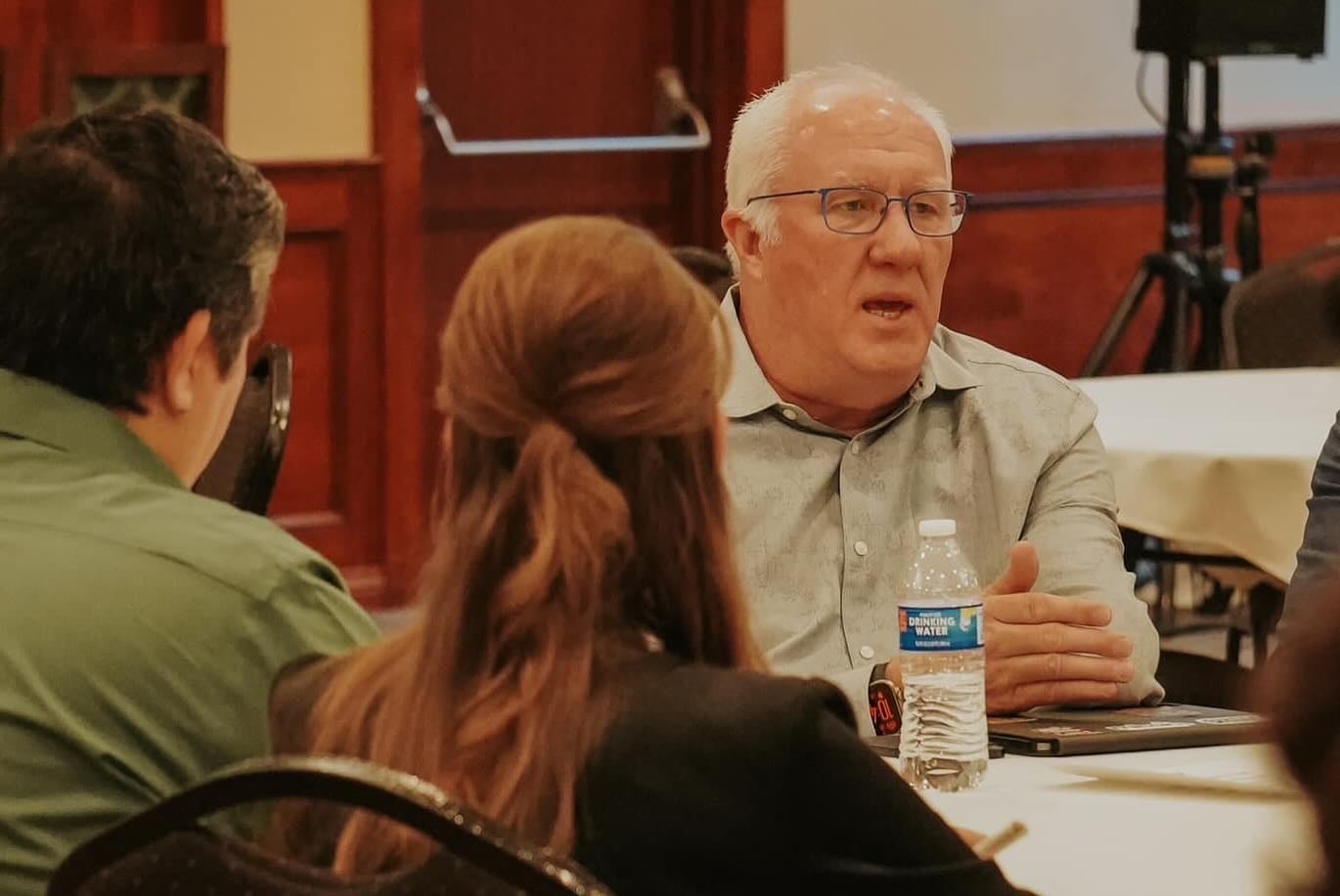 Darin Sargent coaching a leadership team around a table