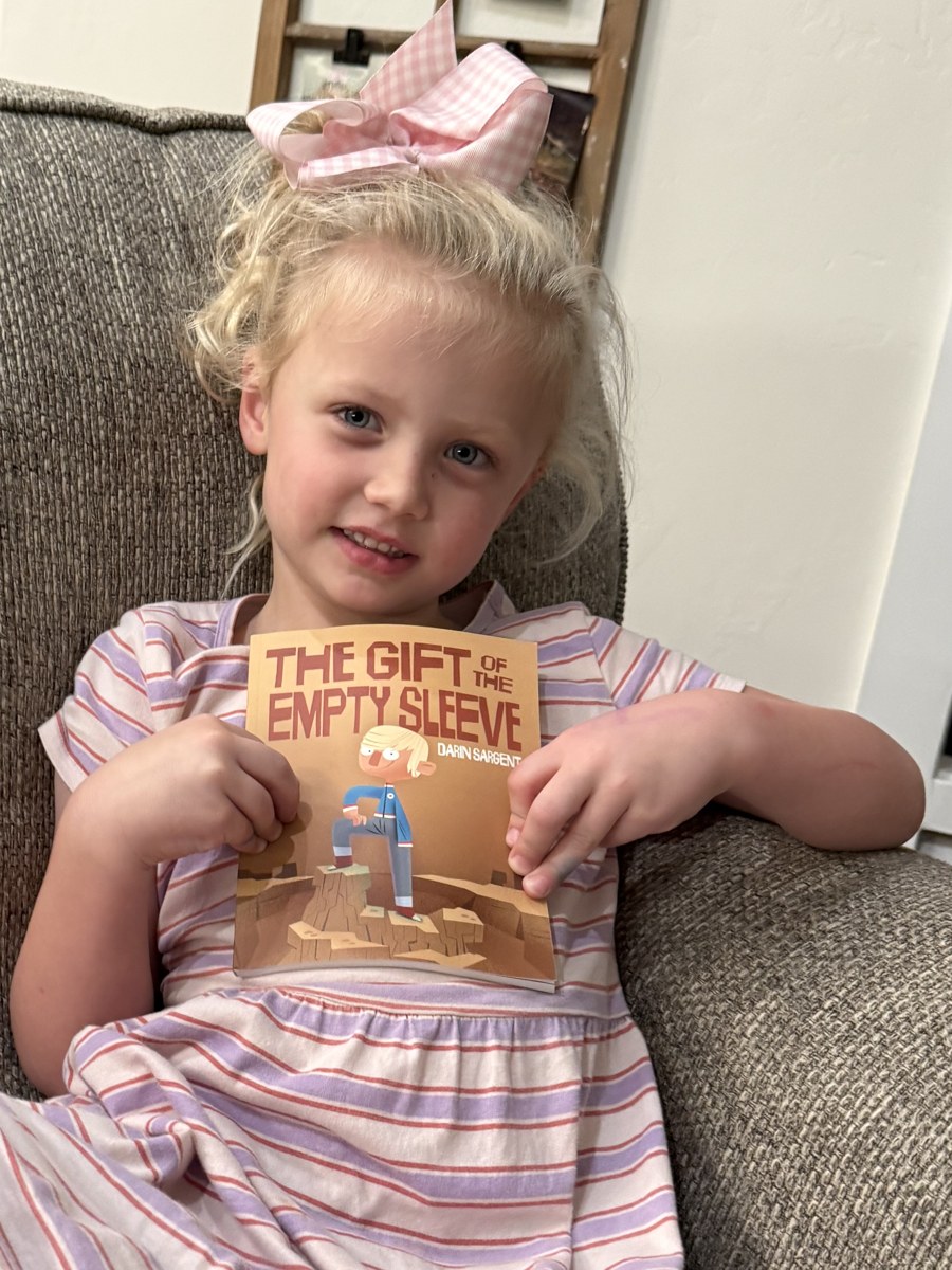 Young reader holding The Gift of the Empty Sleeve